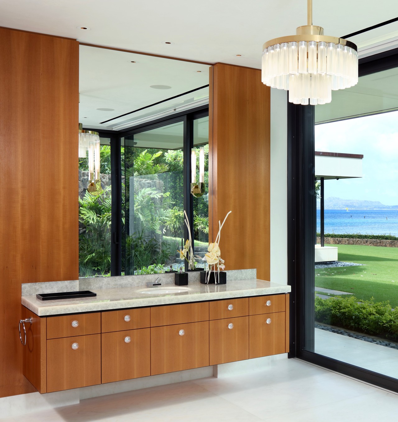 Master bathroom with teak walls and Lalique chandelier at Henry Kaiser estate in Hawaii